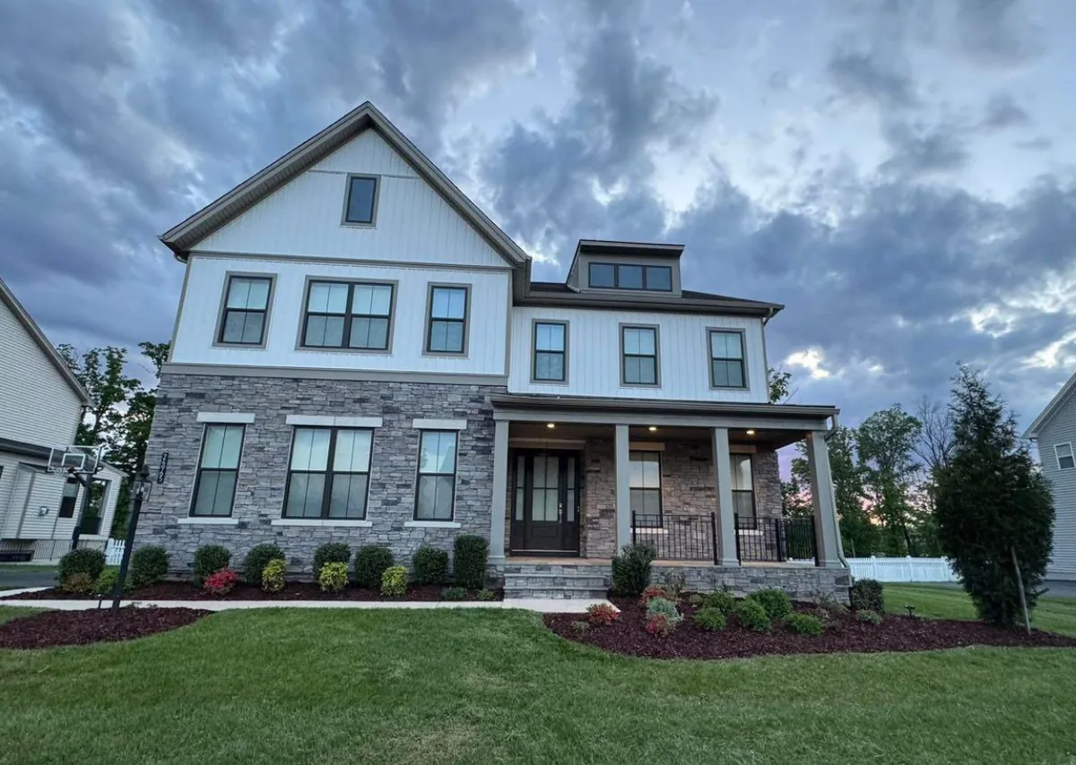 A Northern Virginia home with freshly mulched beds, shaped shrubs and a crisp edge along the lawn.